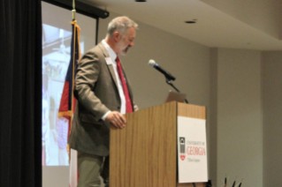 Dr. Michael Toews speaks at a podium