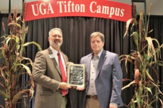 Mickey Dunlap (right) was presented with the 2022 Award of Excellence for Teaching by Dr. Michael Toews