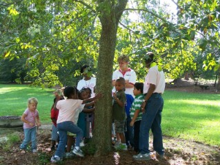 A group of children tour the Coastal Plain Research Arboretum